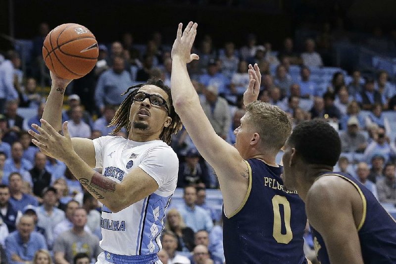 North Carolina guard Cole Anthony (left) drives to the basket against Notre Dame guard Rex Pflueger on Wednesday during the No. 9 Tar Heels’ 76-65 victory over the Fighting Irish in Chapel Hill, N.C. Anthony scored 34 points, setting the school record for scoring by a freshman in his debut, and grabbed 11 rebounds. 