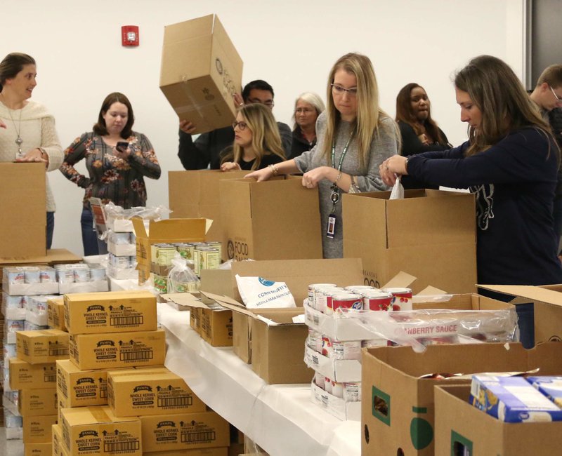 Murphy USA employees fill boxes with dry goods for the Salvation Army Nov. 7, 2019. The company donated about $5,000 to the Arkansas Food Bank.