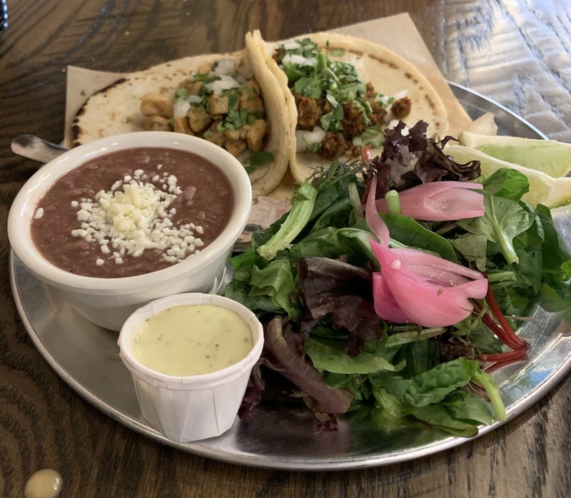 Chicken (left) and chorizo tacos, with beans and a salad, made up a 2 Taco Plate at Mockingbird Bar &amp; Tacos. Arkansas Democrat-Gazeette/ERIC E. HARRISON