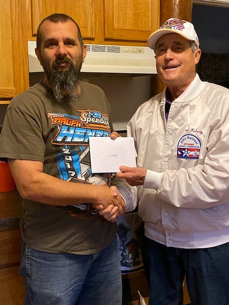 Retired U.S. Army Staff Sgt. Smokey Turner, left, receives a birthday card and gift card from Fred Kelsay, Hot Springs Elks Lodge 380 veterans service officer. - Submitted photo