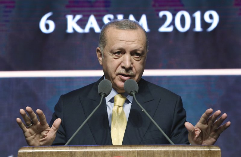 Turkish President Recep Tayyip Erdogan speaks during a meeting in Ankara, Turkey, Wednesday, Nov. 6, 2019. Erdogan says Turkey has captured a wife of the slain leader of the Islamic State group, Abu Bakr al-Baghdadi. Erdogan made the announcement while delivering a speech in Ankara on Wednesday but gave no other details. (Presidential Press Service via AP, Pool)