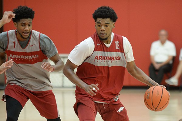 Arkansas guard Mason Jones (15) drives to the lane Thursday, Sept. 26, 2019, as guard Isaiah Joe defends during practice in the Eddie Sutton Gymnasium inside the Basketball Performance Center in Fayetteville. 
