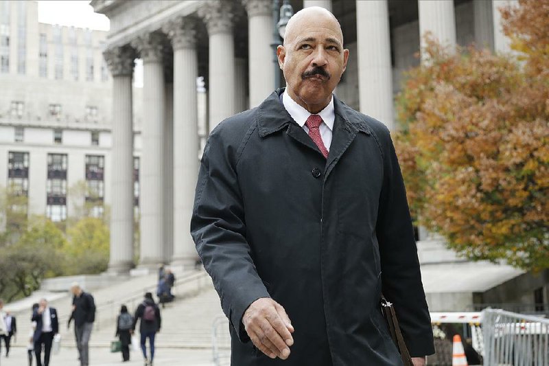 Exxon Mobil Corp. attorney Theodore Wells Jr. leaves court Thursday in New York after closing arguments in a trial over whether Exxon possibly confused or misled investors. 