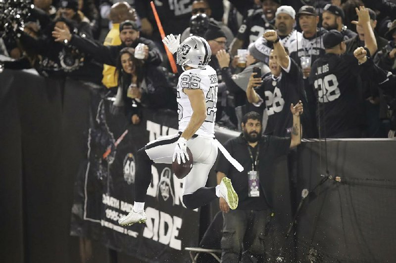 Oakland free safety Erik Harris (25) celebrates after scoring on a 56-yard interception return for a touchdown during the Raiders’ 26-24 victory over the Los Angeles Chargers on Thursday in Oakland, Calif.