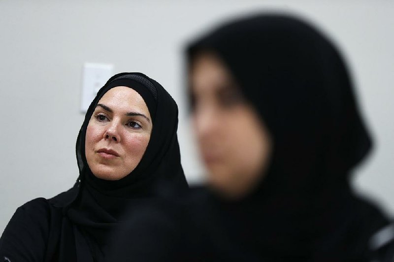 Yasmine Eastman (left) and Amal Faraj listen during a class at the Al-Hujjah Islamic Seminary in Dearborn Heights, Mich. Imam Sayed Mohammad Baqer Al-Qazwini said, “In this seminary, we give voice to the moderate branch of Islam — one that stays true to the text but at the same time is progressive, outgoing, knows how to deal with modern challenges, does not see the western lifestyle as an enemy to Islamic teachings but tries to find a way to be practicing but also be active in your society, to appreciate the country that you live in ... .” 