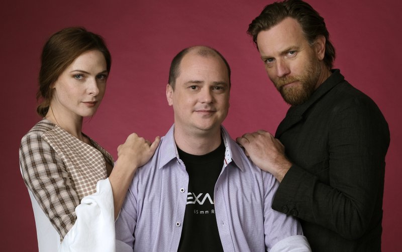 Writer-director Mike Flanagan (center) and actors Rebecca Ferguson (left) and Ewan McGregor pose during a junket to promote Flanagan’s Doctor Sleep. 