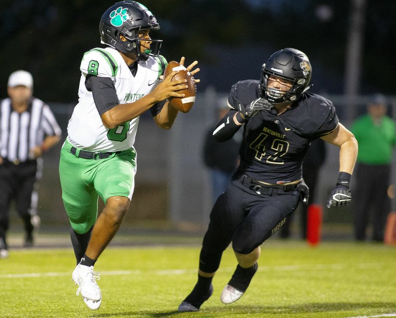 Special to NWA Democrat-Gazette/ David Beach Van Buren junior quarterback Gary Phillips is chased by Cole Joyce( 42) of Bentonville High in a 7A-West Conference game. 