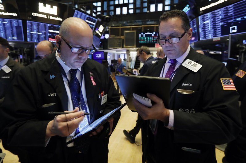 Traders Jeffrey Vazquez, left, and Edward Curran work on the floor of the New York Stock Exchange, Thursday, Nov. 7, 2019. (AP Photo/Richard Drew)