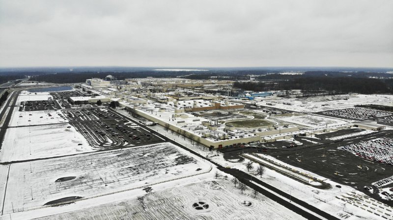 In this Nov. 28, 2018, file photo snow covers the perimeter of the General Motors' Lordstown plant in Lordstown, Ohio. General Motors is selling the Ohio assembly plant it closed in March to a new company that plans to begin making electric trucks in late 2020. (AP Photo/John Minchillo, File)