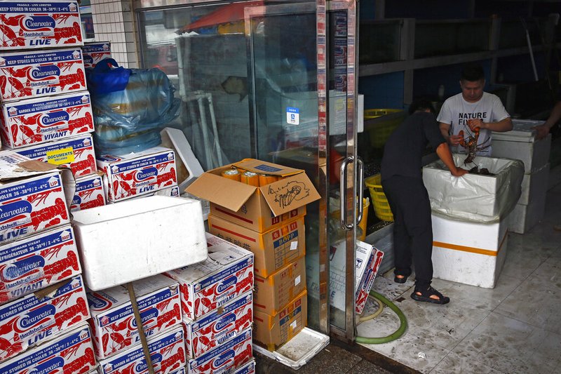 FILE - In this July 12, 2018, file photo, worker pack imported lobsters at the Jingshen seafood market in Beijing. U.S.-Chinese trade contracted again in October, despite optimism about possible progress in talks aimed at ending a tariff war that threatens global economic growth. Chinese imports of U.S. goods fell 14.3% from a year earlier to $9.4 billion, customs data showed Friday, Nov. 8, 2019. (AP Photo/Andy Wong) story.lead_photo.caption