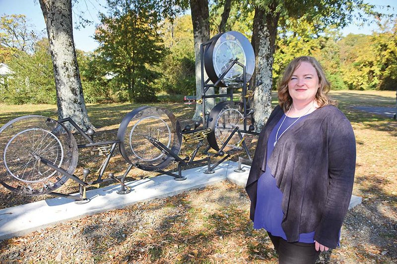 Joanna Nabholz, an architect and president of the Conway Public Art Board, stands in Airport Park with Bluescycle, a sculpture made of five interconnected bicycle frames outfitted with horns and wheels. The interactive musical piece, created by Texas artist Steve Parker, was installed in October. The board’s next project is two 15-foot-high LED light towers, which will be somewhere on Sixth Street, Nabholz said.