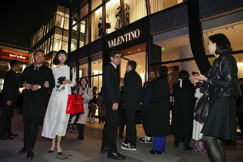 Guests attend a cocktail party this week for the new Valentino boutique store at a mall in Beijing ahead of Singles Day shopping that starts Monday. 