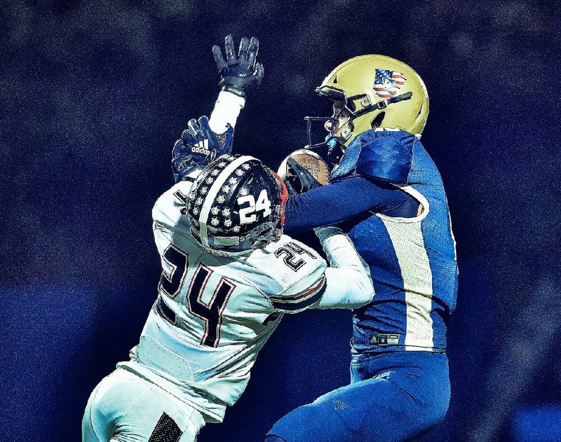 Pulaski Academy receiver Andrew Cobb (right) catches a pass over White Hall free safety Braylon  Johnson (24) during the Bruins’ 68-21 victory over the Bulldogs on Friday night. More photos at  arkansasonline.com/119whitehallpulaski. 