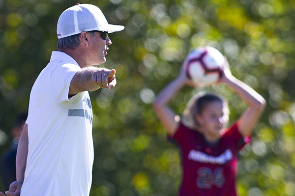 Arkansas soccer coach Colby Hale yells to his team while Abbi Neece prepares for a throw in during a game against Georgia on Sunday, Oct. 27, 2019, in Fayetteville.
