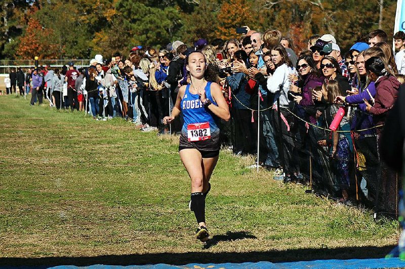 Rogers' Ali Nachtigal crosses the finish line to win the Class 6A state cross country final on the infield of Oaklawn Park.