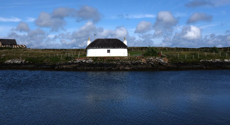 A restored crofter's cottage sits above tidal pools on South Uist in Scotland. Crofters, who raise sheep and cattle, use traditional methods that enhance the natural beauty of the Uist islands. (Photo by Adrian Higgins via The Washington Post)