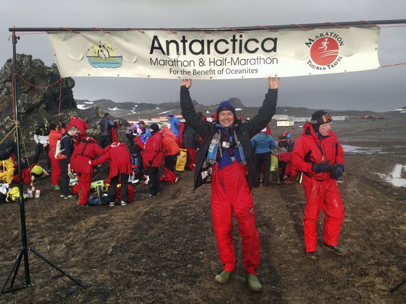 Michael Clinton poses at the Antarctica marathon. Running a marathon abroad is a perfect way to see the world with people who have the same interests. (Mariusz Szeib via The New York Times)