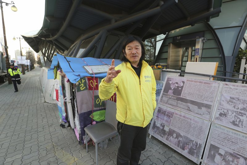 In this April 2, 2019, photo, Choi Seung-woo, a victim of Brothers Home, speaks during an interview in front of National Assembly in Seoul, South Korea. Choi and a small number of other Brothers Home inmates have been camping out in front of the National Assembly&#x2019;s gate for more than two years calling for lawmakers to pass a bill that would launch a full investigation into past human rights atrocities, including the Brothers Home incident. Notorious South Korean facility that kidnapped, abused and enslaved children and the disabled for a generation was also shipping children overseas for adoption as part of a massive profit-seeking enterprise. (AP Photo/Ahn Young-joon)