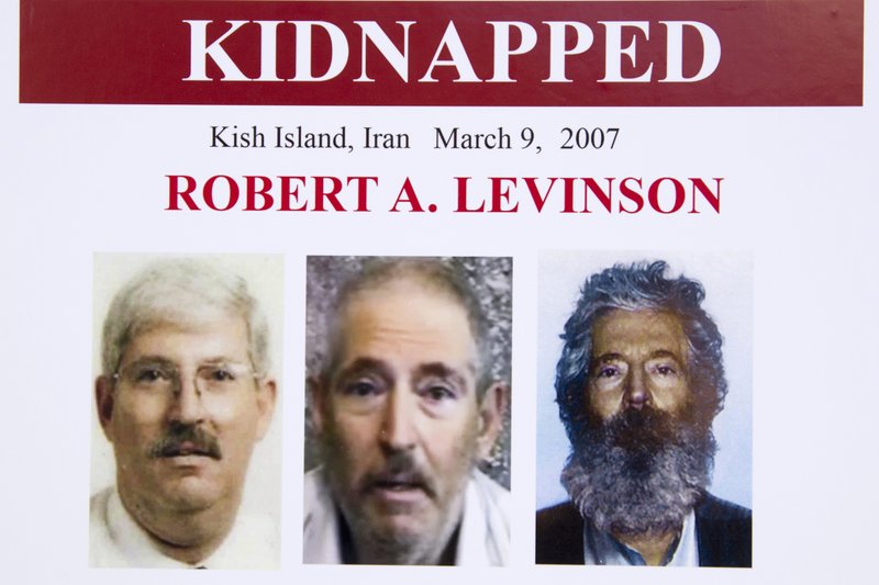 FILE - In this March 6, 2012, file photo, an FBI poster showing a composite image of former FBI agent Robert Levinson, right, of how he would look like now after five years in captivity, and an image, center, taken from the video, released by his kidnappers, and a picture before he was kidnapped, left, displayed during a news conference in Washington. Iran is acknowledging for the first time it has an open case before its Revolutionary Court over the 2007 disappearance of a former FBI agent on an unauthorized CIA mission to the country. In a filing to the United Nations, Iran said the case over Robert Levinson was &quot;on going,&quot; without elaborating. The Associated Press obtained the text of the filing Saturday, Nov. 9, 2019. (AP Photo/Manuel Balce Ceneta, File)