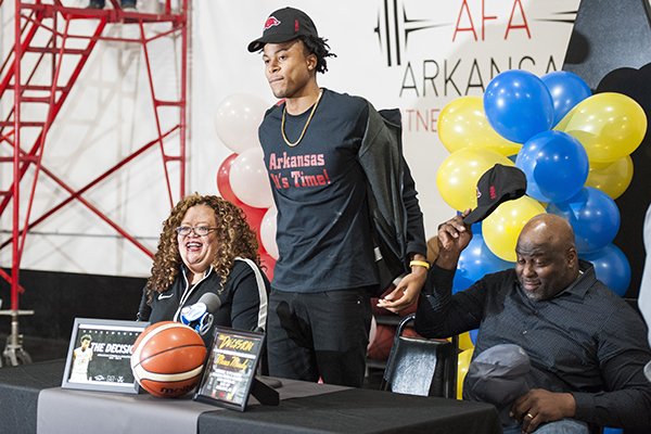 Moses Moody (center) reveals his commitment at Arkansas Fitness and Athletics in Little Rock on Saturday, Nov. 9, 2019, in Little Rock. 

