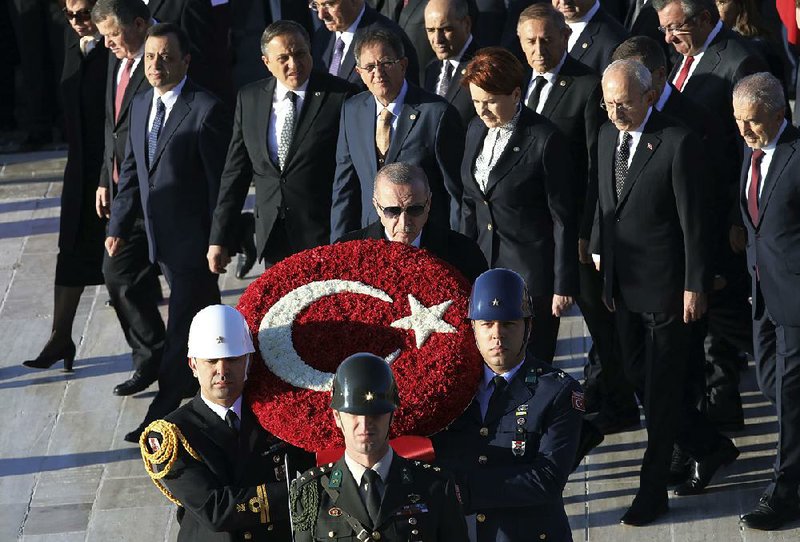 Turkish President Recep Tayyip Erdogan (front, upper center) and other leaders follow a military honor guard Sunday during a ceremony in Ankara commemorating Mustafa Kemal Ataturk on the 81st anniversary of his death. Ataturk is considered the founder of modern Turkey. 