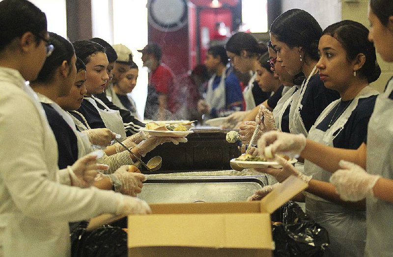 Students from La Joya High School volunteer Sunday during the annual HEB Feast of Sharing at the McAllen Convention Center in McAllen, Texas. 