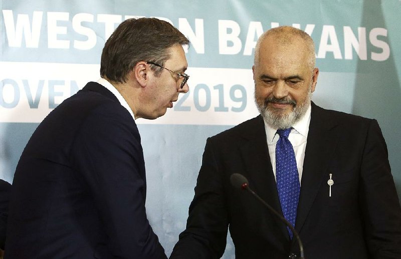 Serbian President Aleksandar Vucic (left) greets Albanian Prime Minister Edvin Rama during a joint news conference Sunday in Ohrid, North Macedonia. 