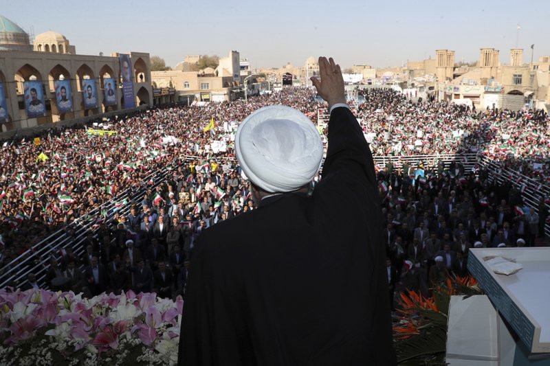 In this photo released by the official website of the office of the Iranian Presidency, President Hassan Rouhani waves to the crowd in a public gathering at the city of Yazd, some 410 miles (680 kilometers) southeast of the capital Tehran, Iran, on Sunday. Iran has discovered a new oil field in the country's south with over 50 billion barrels of crude oil, Rouhani said Sunday, a find that could boost the country's proven reserves by a third as it struggles to sell energy abroad over U.S. sanctions. - Office of the Iranian Presidency via AP