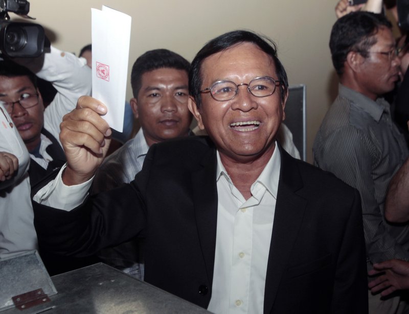 FILE - In this June 4, 2017, file photo, then opposition Cambodia National Rescue Party President Kem Sokha shows off his ballot before voting in local elections in Chak Angre Leu on the outskirts of Phnom Penh, Cambodia. A Cambodian court has lifted some restrictions on detained opposition leader Kem Sokha, freeing him from virtual house arrest. The Sunday, Nov. 10, 2019, action came a day after his co-founder of the Cambodia National Rescue Party, Sam Rainsy, arrived in Malaysia on a well-publicized trip to return to Cambodia to lead a movement to oust long-serving authoritarian Prime Minister Hun Sen. (AP Photo/Heng Sinith, File)