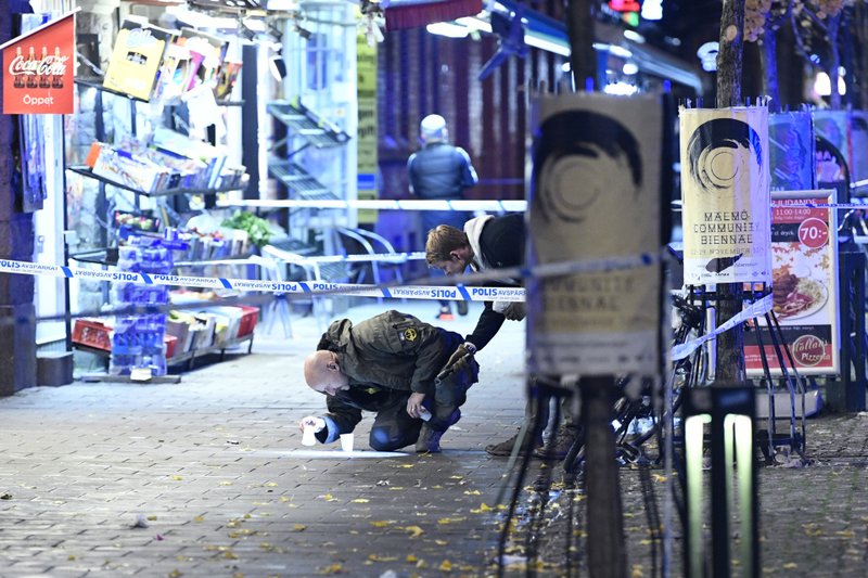 In this photo taken late Saturday, Nov. 9, 2019, a policeman works near the scene of a shooting, in Malmo, Sweden. A 15-year-old boy was killed and another teenager was in critical condition after a shooting in a busy square in the southern city of Malmo, Swedish police said Sunday. Similar incidents and explosions in Malmo recently have alarmed politicians and residents. (Johan Nilsson/TT News Agency via AP)