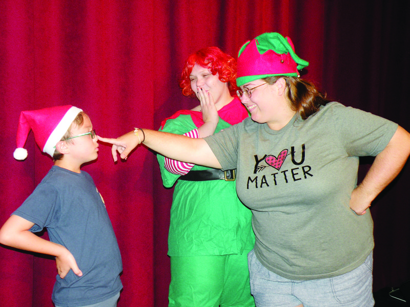 Mistletoe Merryman, second from left, played by Amanda Autry, and Holly Daze, right, played by Irene Taylor, portray elfin hosts for the talent show in North Pole’s Got Talent. They work with Coal, played by Johnny Bertram, who is the keeper of the “naughty and nice” list for Santa and stage manager of the talent show in the upcoming production at the Rialto Community Arts Center.