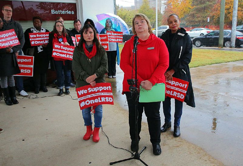 Little Rock Education Association President Teresa Knapp Gordon (center) announces the strike at a news conference Monday in front of the Central High School National Historic Site. She was joined by Wendy Sheridan (left), a school district parent, and by state Sen. Joyce Elliott. 