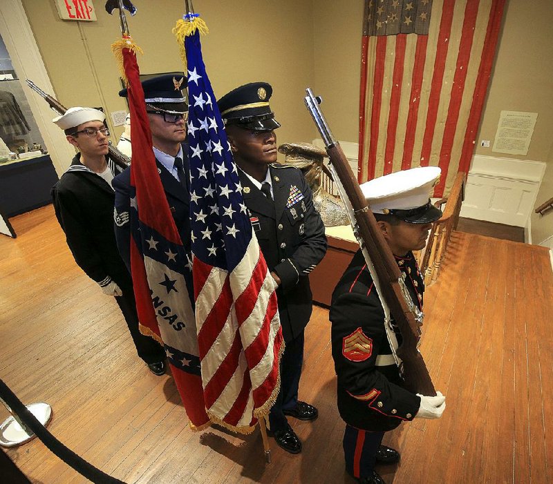 The Governor’s Joint Honor Guard prepares to present the colors Monday before the Veterans Day ceremony at the MacArthur Museum of Arkansas Military History in Little Rock. More photos are available at arkansasonline.com/1112veterans/. 