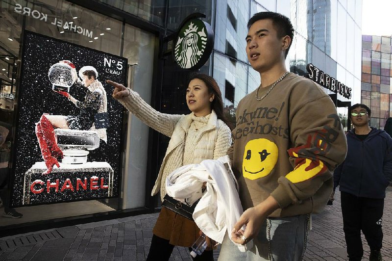 Shoppers scout for bargains at a popular Beijing retail district on Sunday, the eve of Singles Day, a shopping holiday invented in the 1990s that has become the world’s busiest day for online commerce. 