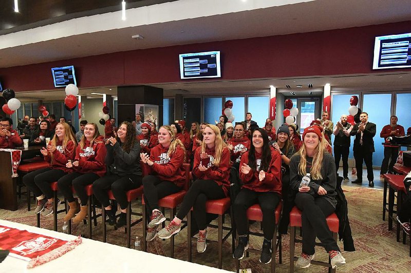 Members of the Arkansas soccer team cheer during a watch party after learning the Razorbacks will host North Texas in a first-round match at 6:30 p.m. Friday at Razorback Field in Fayetteville. 