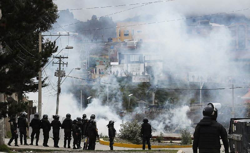 Police use tear gas Monday in La Paz, Bolivia, during clashes with supporters of former President Evo Morales. More photos are available at arkansasonline.com/1112bolivia/ 