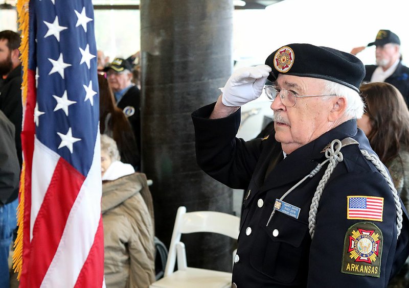 VFW Post 2278 Honor Guard member Harry Davis salutes the American flag during the Veterans Day Service held Monday morning, Nov. 11, 2019, at the Hot Springs Farmers & Artisans Market pavilion to honor all U.S. military veterans. - Photo by Richard Rasmussen of The Sentinel-Record
