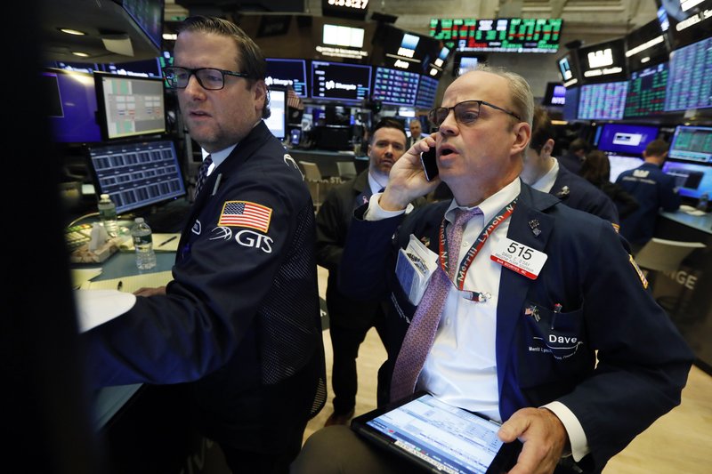 FILE - In this Nov. 7, 2019, file photo specialist Gregg Maloney, left, and trader David O'Day work on the floor of the New York Stock Exchange. The U.S. stock market opens at 9:30 a.m. EST on Monday, Nov 11. (AP Photo/Richard Drew, File)