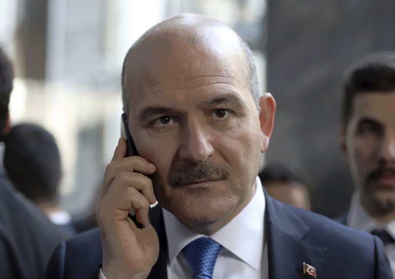 FILE - In this Wednesday, Nov. 5, 2019 file photo, Turkey's Interior Minister Suleyman Soylu speaks on the phone in Ankara, Turkey. A U.S. national who is a member of the Islamic State group has been deported home on Monday, Nov. 11, 2019, a Turkish official said, and Interior Minister Soylu has said Turkey which holds about 1,200 foreign IS fighters in Turkish prisons, will start repatriating captured foreign IS fighters as of Monday.(AP Photo/Burhan Ozbilici, File)