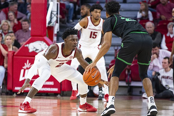 Arkansas' Adrio Bailey (2) and Mason Jones (15) play defense during a game against North Texas on Tuesday, Nov. 12, 2019, in Fayetteville.