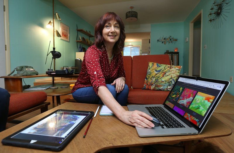 NWA Democrat-Gazette/DAVID GOTTSCHALK Melissa Milton displays her website Tuesday, October 29, 2019, that populated with her new media digital painting at her home in Fayetteville.