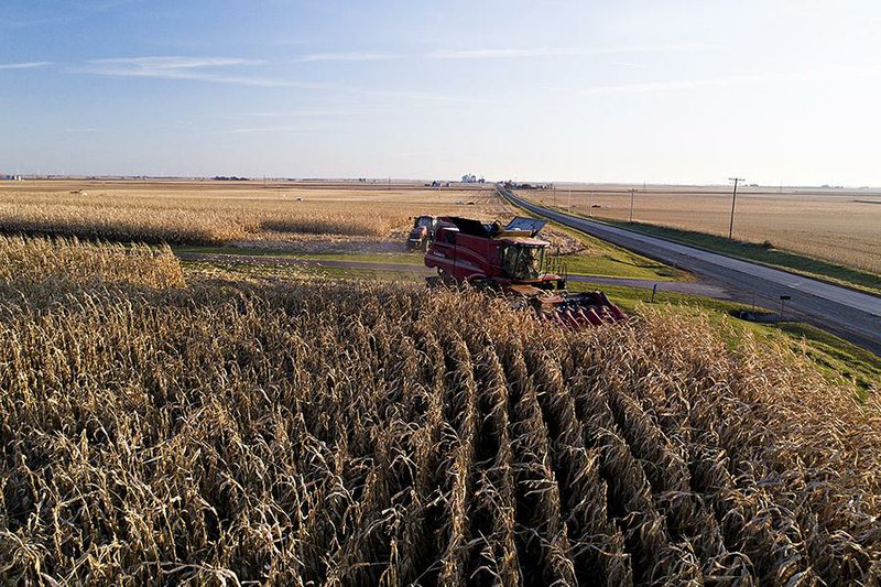 A farmer drives a combine harvester through a cornfield last week near Buda, Ill. Senate Democrats say President Donald Trump’s farm trade aid program is unfair to farmers in the Midwest and Northern Plains. 