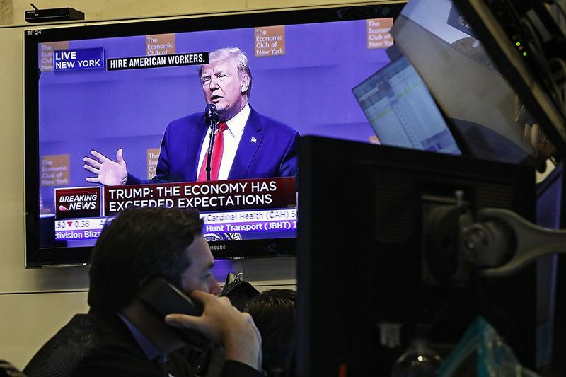 A television screen at the New York Stock Exchange shows President Donald Trump’s speech Tuesday at the Economic Club of New York, but his comments caused little reaction in the stock market.