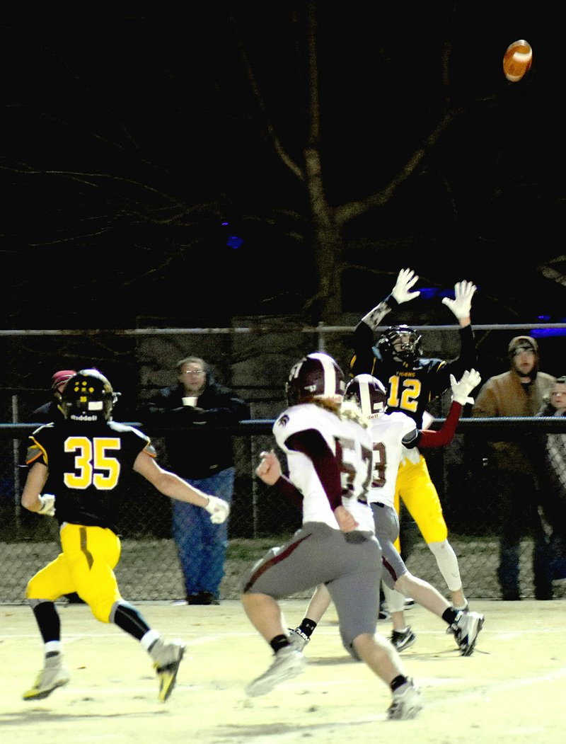 MARK HUMPHREY ENTERPRISE-LEADER Prairie Grove sophomore Landon Semrad goes up to catch a pass from quarterback Knox Laird during Friday's season finale against Lincoln. The Tigers beat the Wolves, 34-14, in what may be the last game of a long standing rivalry that marked the 60th game in the series. Lincoln reverts to the 3A classification for football next season while Prairie Grove remains a 4A school. The Tigers lead the series 43-17.