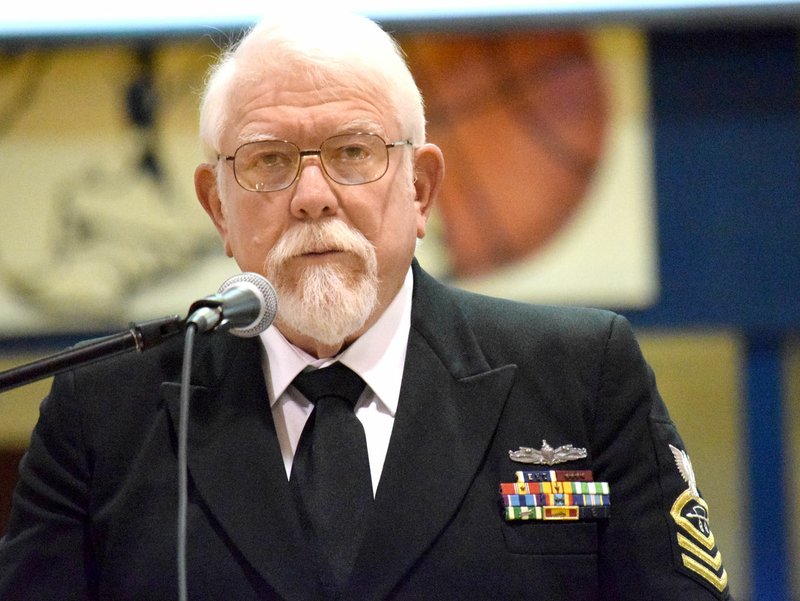 Westside Eagle Observer/MIKE ECKELS Ron Evans, a retired Navy veteran, gives a speech honoring his many colleagues during the Decatur High School Veterans Day program Thursday at Peterson Gym.