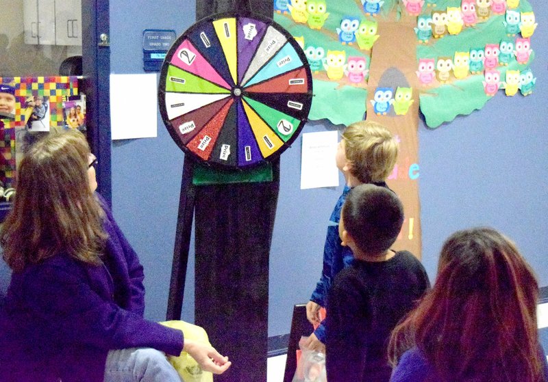 Westside Eagle Observer/MIKE ECKELS A Northside student (upper right) tries his luck at the Wheel of Fortune game during the Friday night Northside Elementary's fall festival in Decatur.