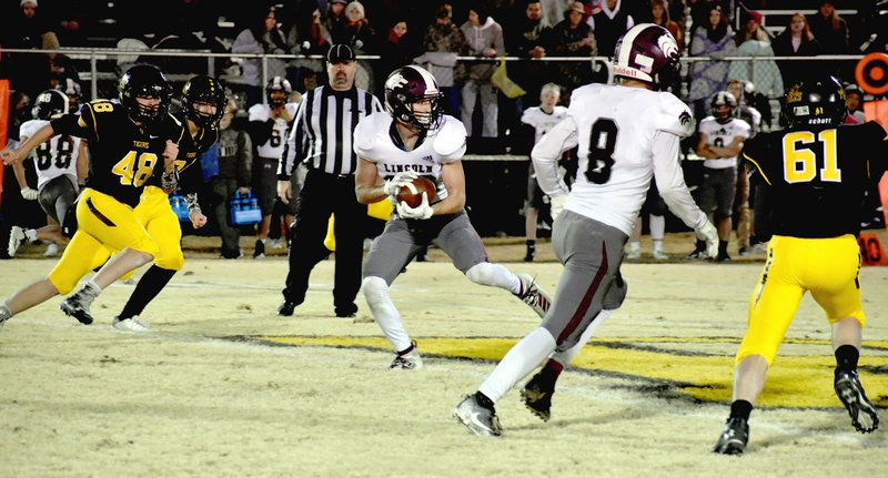 MARK HUMPHREY ENTERPRISE-LEADER/Lincoln junior Daytin Davis scored on this play after catching a short pass. He eluded and outran Prairie Grove defenders to complete a 51-yard pass play. Lincoln, however, couldn't get past Prairie Grove, losing 34-14 Friday. Prairie Grove's season continues with a trip to Hamburg Friday for a first-round playoff game.