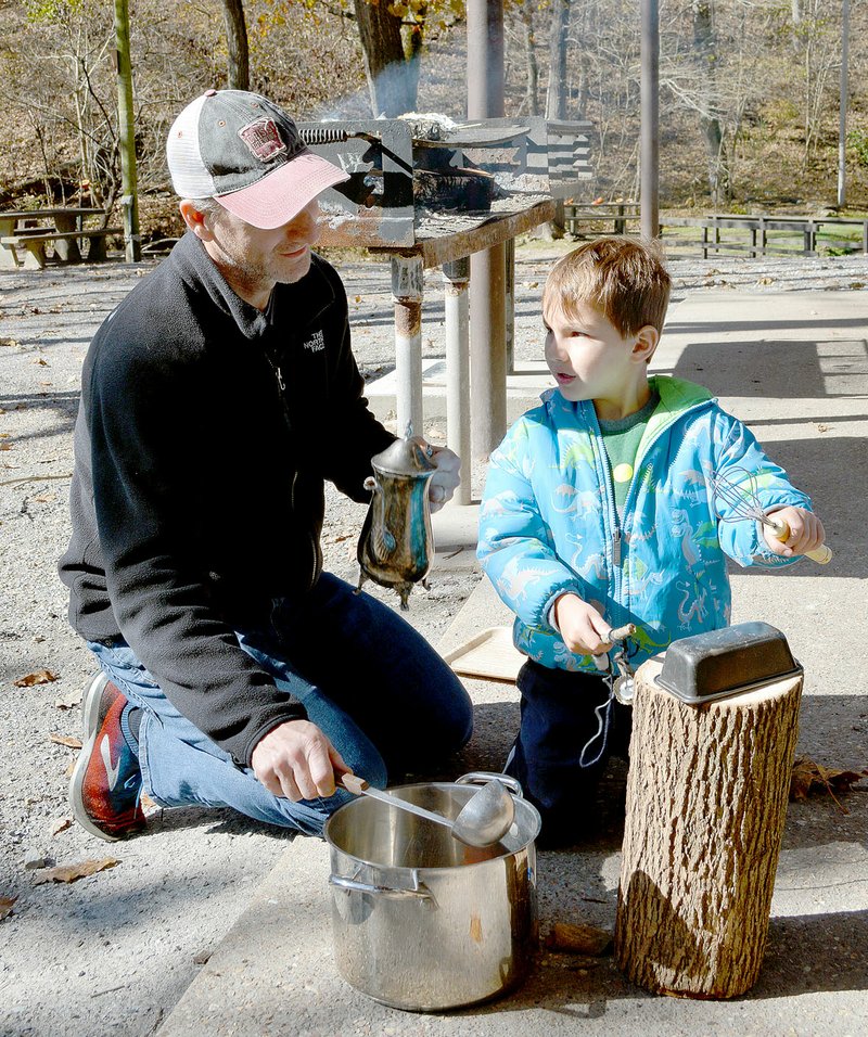 Keith Bryant/The Weekly Vista Drake Branch (left) collaborates with his son, Harrison Branch, 5, using pots and pans to make a tune.