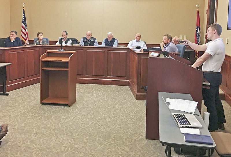 NWA Democrat-Gazette/MIKE JONES Bentonville's Planning Commission discusses waivers Tuesday night for the Suite Spaces building expansion. The waivers dealt with screening and sidewalk requirements and street standards. The applicant proposes an extension of the structure.