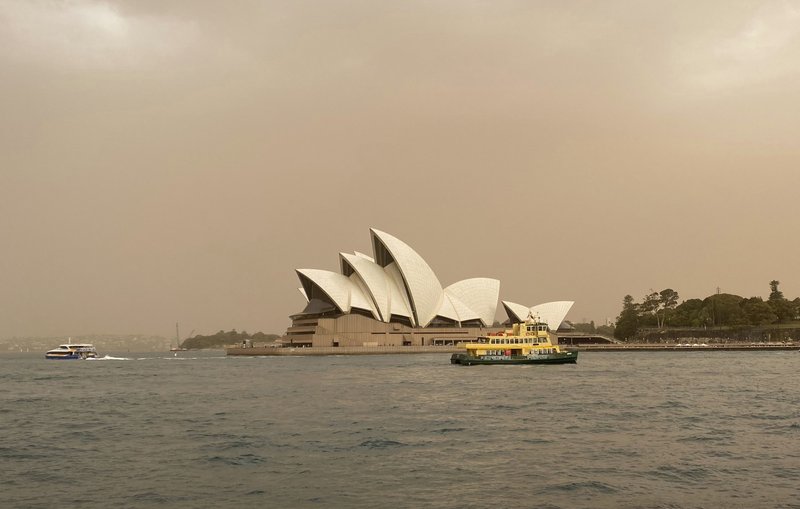 Sydney Opera House is backdropped by haze from wildfires near the city, in Sydney, Australia, Tuesday Nov. 12, 2019.  Authorities have declared a state of emergency as ferocious wildfires are burning across Australia's most populous state and into the suburbs of Sydney on Tuesday, with winds carrying embers for kilometers (miles) and igniting new fire spots. (Mette Estep / NTB scanpix via AP)